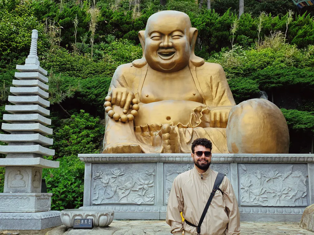 Standing in front of the golden Laughing Buddha at Haedong Yonggungsa temple