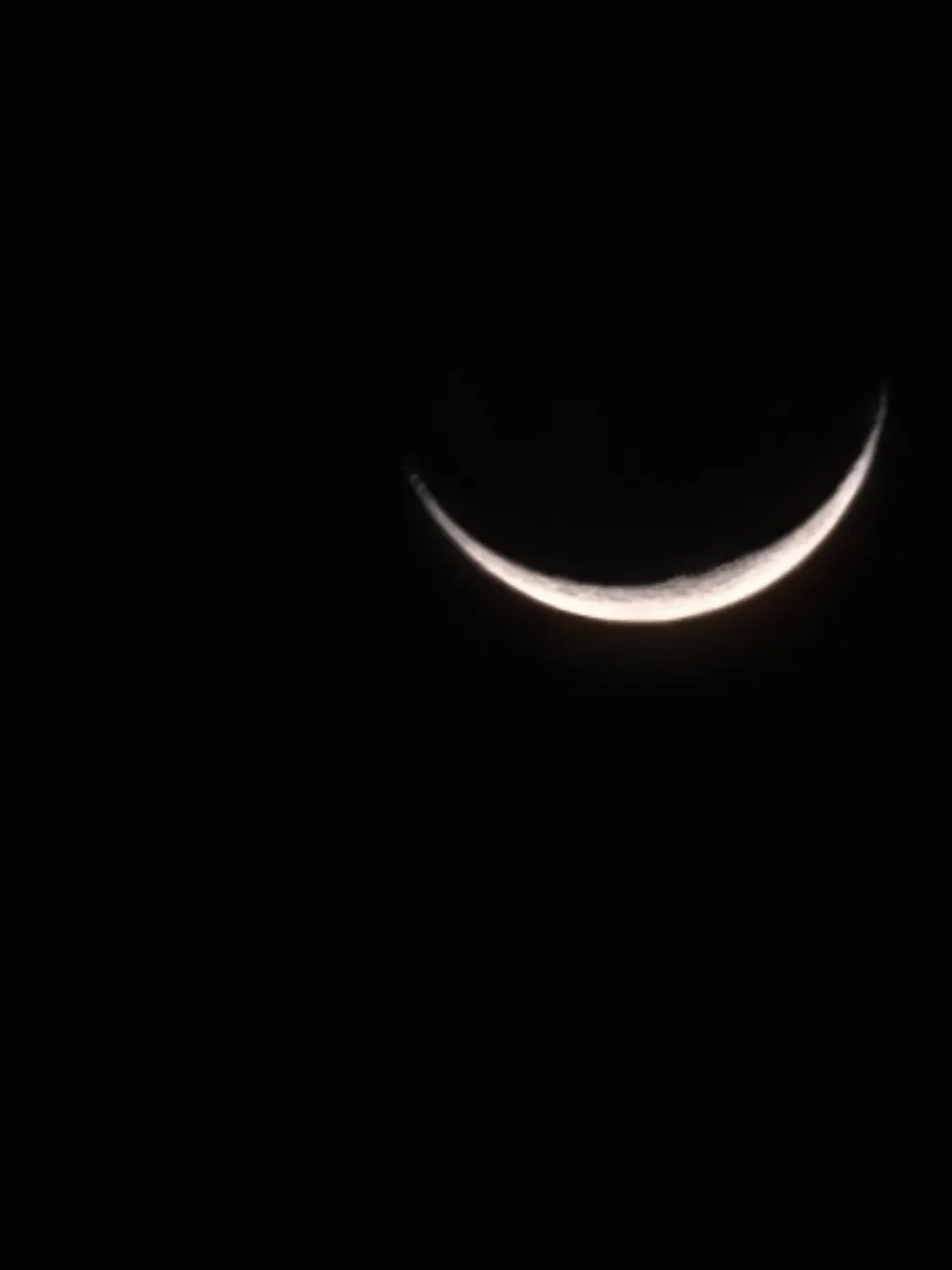 Thin crescent moon low in the sky
