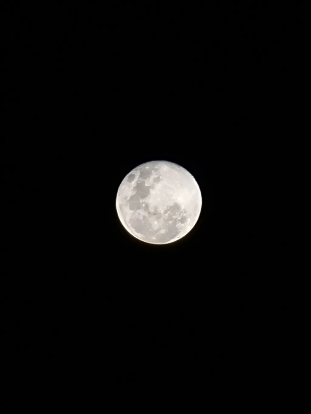 Full moon photographed against a black sky